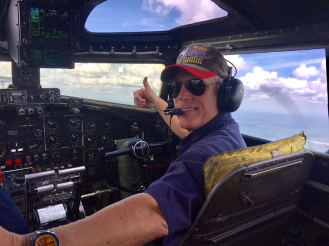 A man in the cockpit of an airplane.