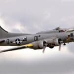 A large military plane flying through the sky.