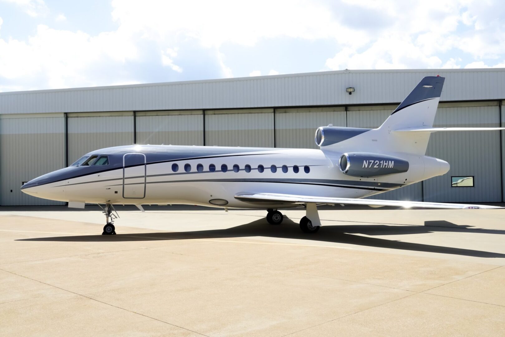 A small jet sitting on top of an airport runway.