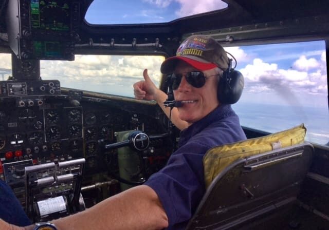 A man in the cockpit of an airplane.