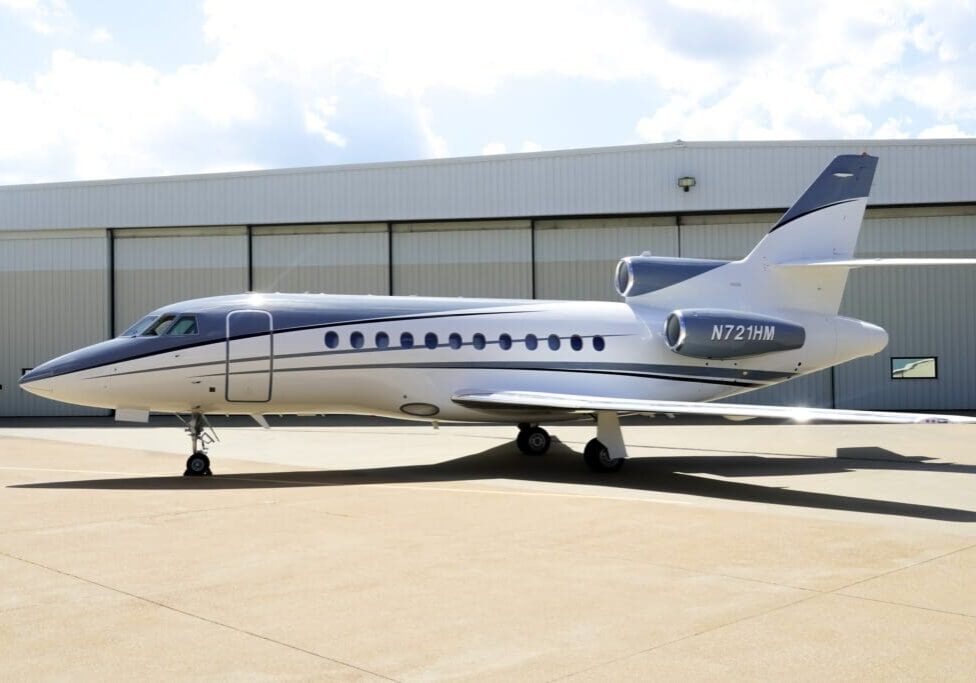 A small jet sitting on top of an airport runway.