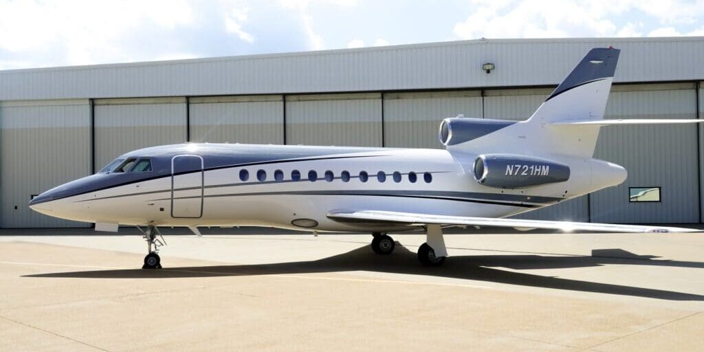 A small jet sitting on top of an airport runway.