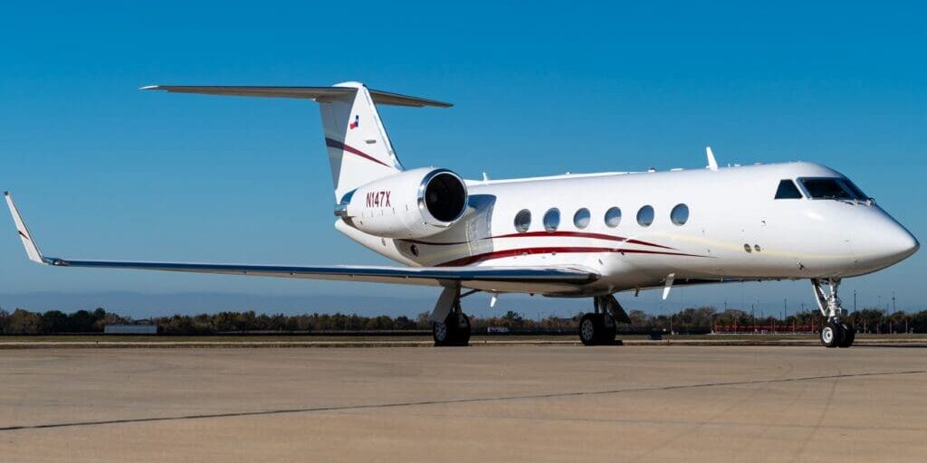 A small white plane sitting on top of an airport runway.