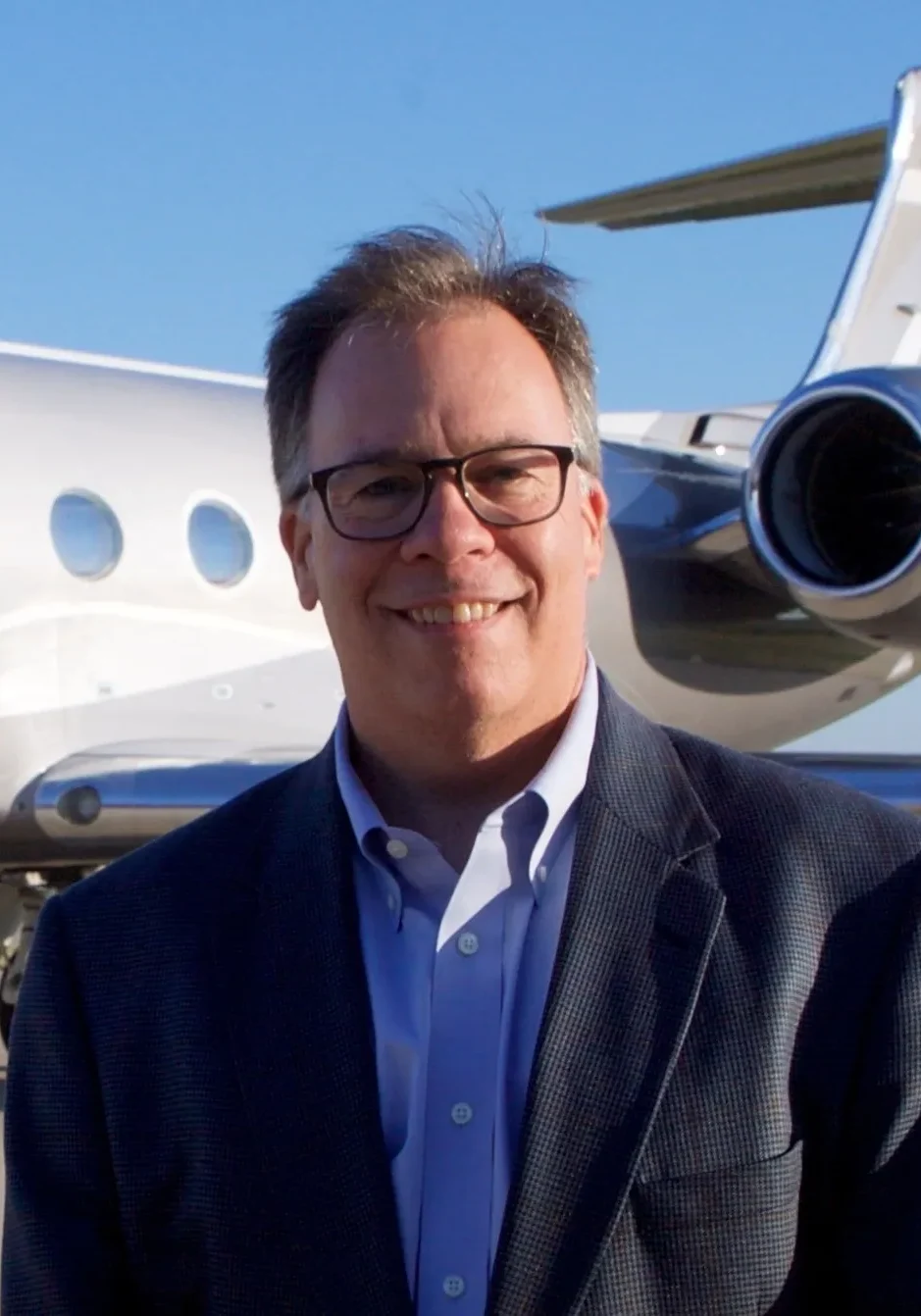 A man standing in front of an airplane.