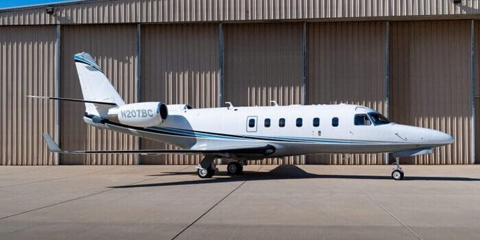 A small white plane parked on the tarmac.